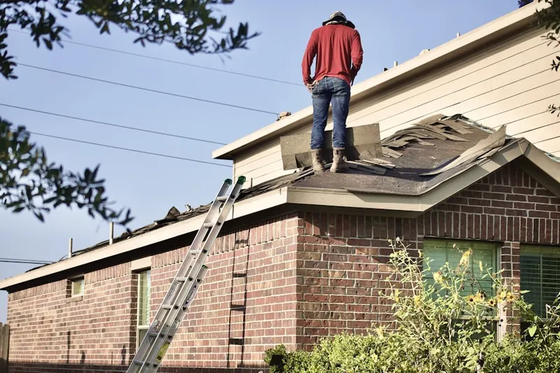 Professional roofer working on a residential roof in Bucktown